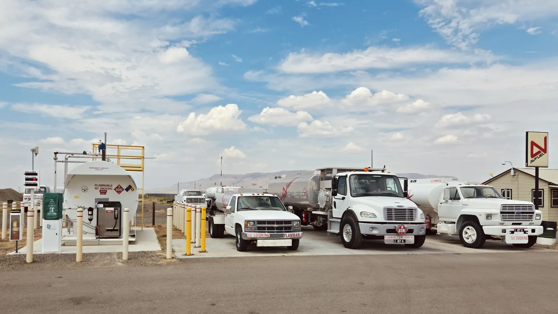 Self-serve 100LL tank and AvFuel full-service trucks lined up at the fuel dock at Battle Mountain Airport